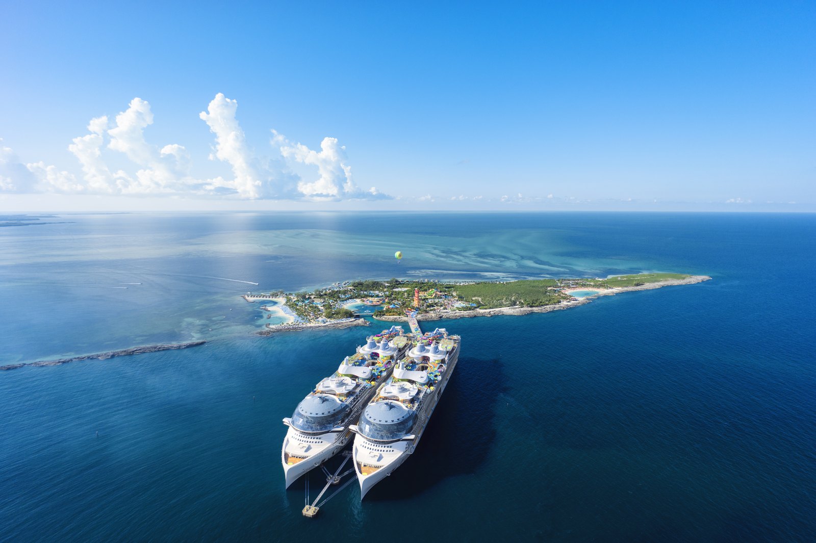 Perfect Day CocoCay from the air with two Icon Class ships alongside