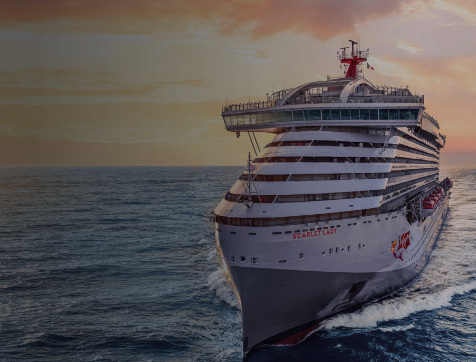 Virgin Voyages Scarlet Lady at sea at sunset